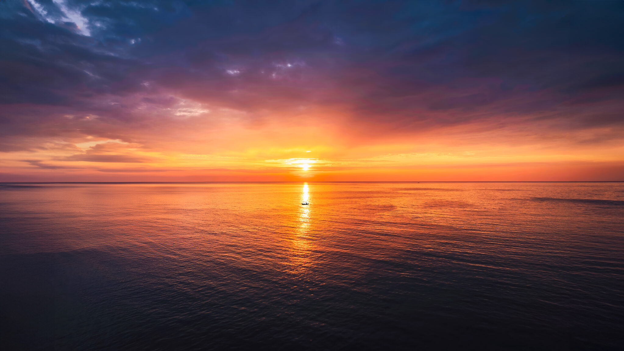 Aerial view of beautiful sunset over tropical sea with tourists rowing canoe and enjoy the view in summer at Koh Kood Island